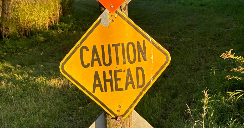 A beat-up caution sign, indicating to women to watch out for the cheating, narcissist, ex.