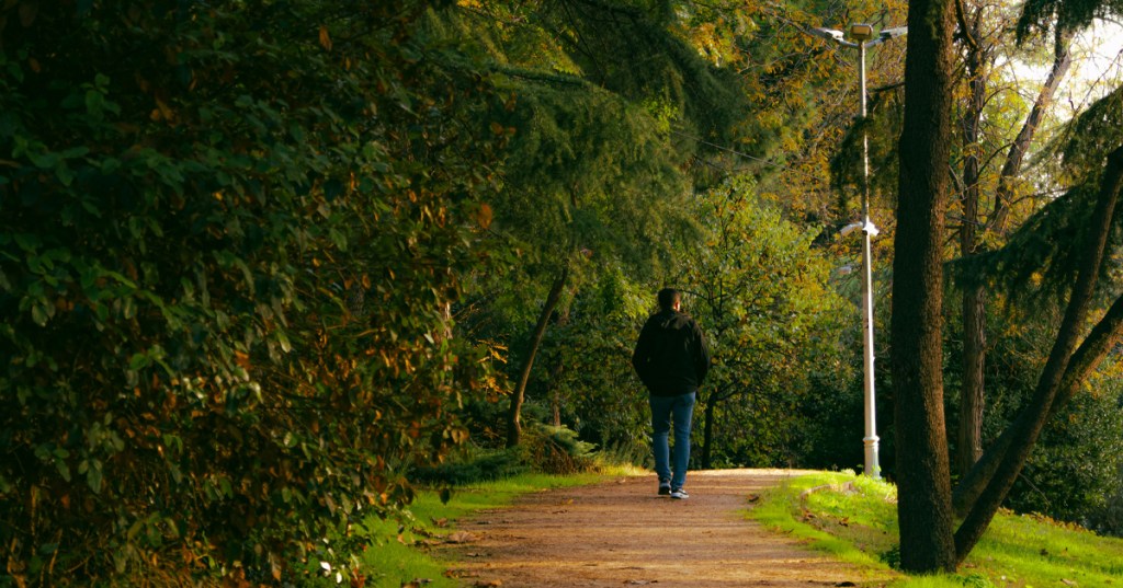 A man walking down the road and away from a long relationship or marriage after he destroyed the woman in his life.