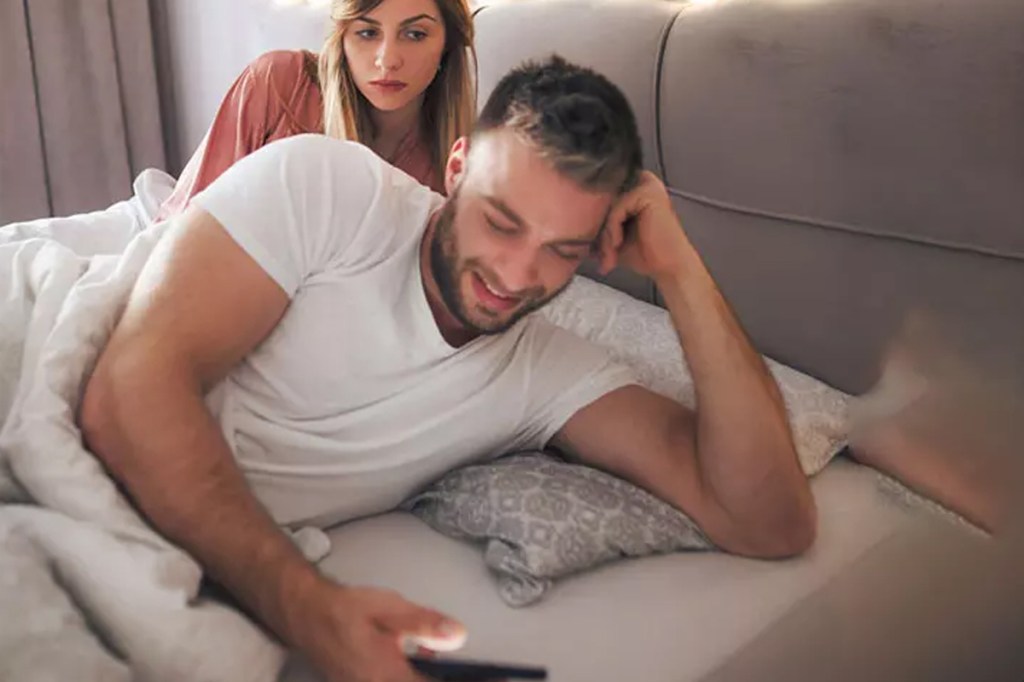 Man happily texting secretly while woman feels suspicious and left out.
